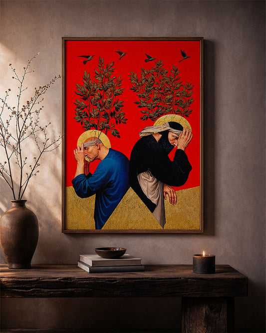 Framed surreal poster of two figures with trees growing from their heads displayed on a wooden shelf against a neutral wall
