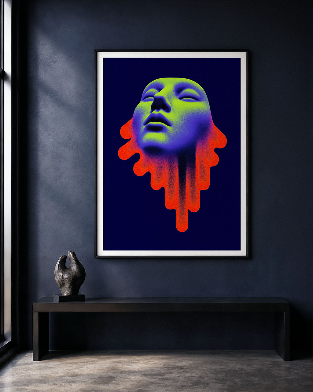 Framed Acid Saint poster displayed on a dark modern wall above a black bench with a small sculpture.