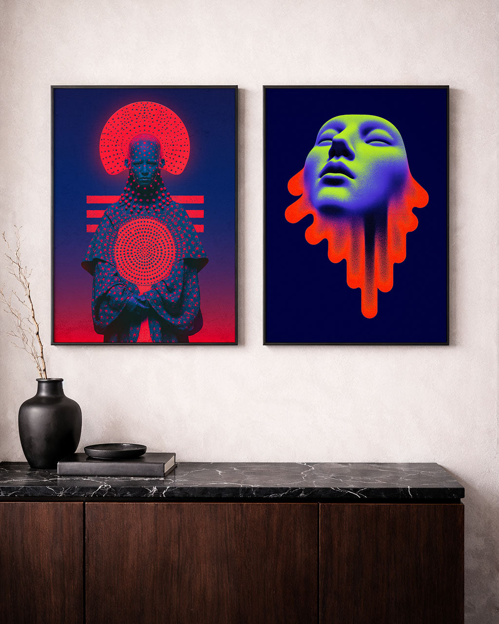 Two framed surreal art posters displayed above a dark wooden cabinet. Acid Saint on the right and Transmission on the left.
