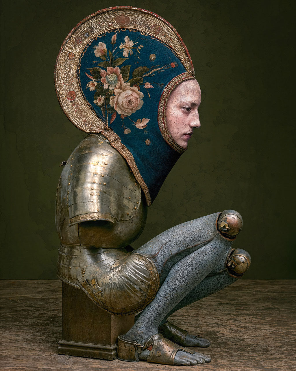 Surreal armoured figure without arms wearing an intricate floral headpiece