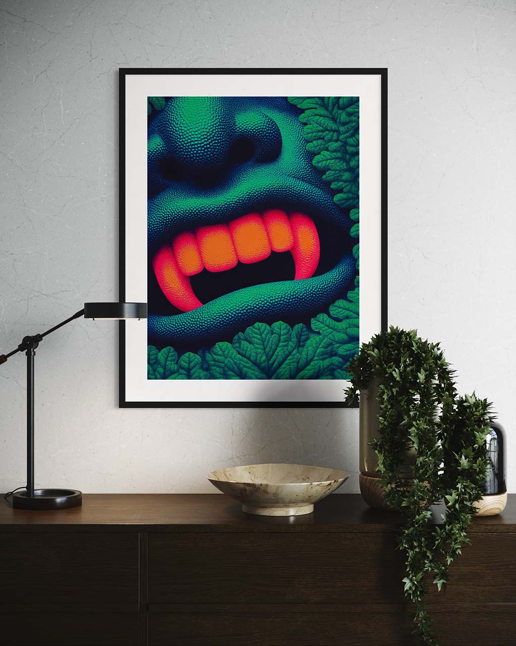 Art poster hanging on the wall in modern setting. The poster features bright orange fangs surrounded by vibrant, green leaves.