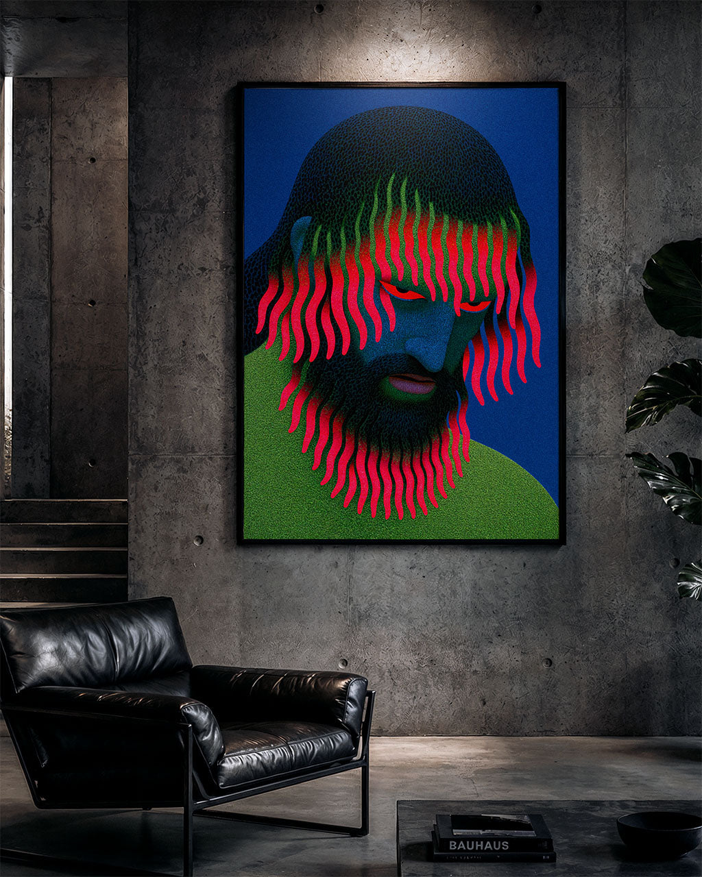 Large Growing Pains art print in a black frame on a concrete wall above a black leather armchair in a dark, minimalist industrial interior.