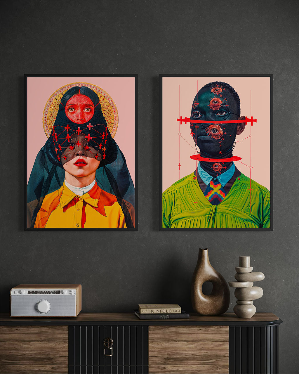 Two surreal posters hanging side by side on a dark wall, one showing stacked faces connected by red crosses and the other a masked figure with mechanical eye motifs.