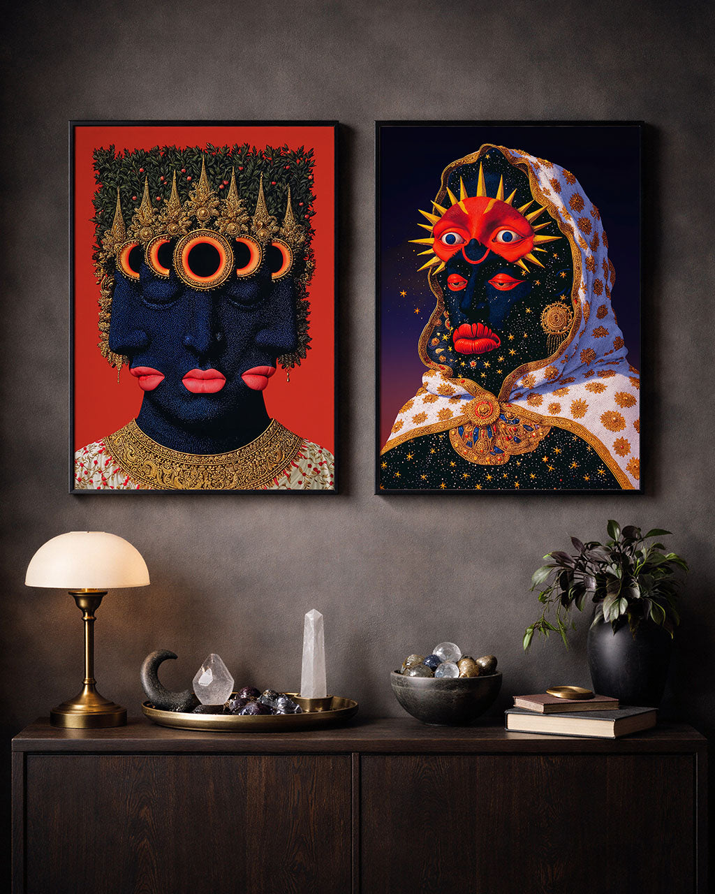 Murdeshwar poster paired with a celestial portrait poster in black frames above a dark wooden cabinet with lamp, crystals, books and plant.