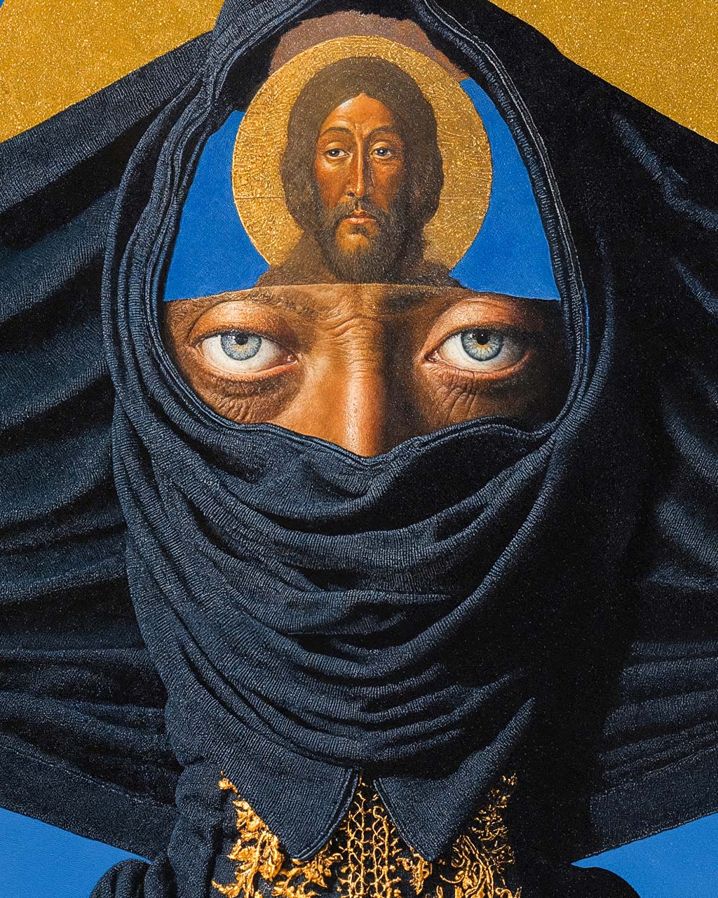 Closeup of a surreal portrait of a veiled figure with blue eyes and a haloed religious face above