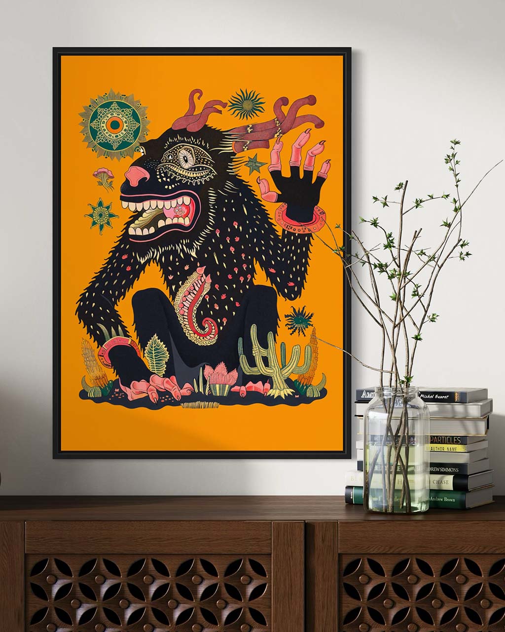 Framed art poster on the wall. The poster features an illustration of a strange creature waving its hand.