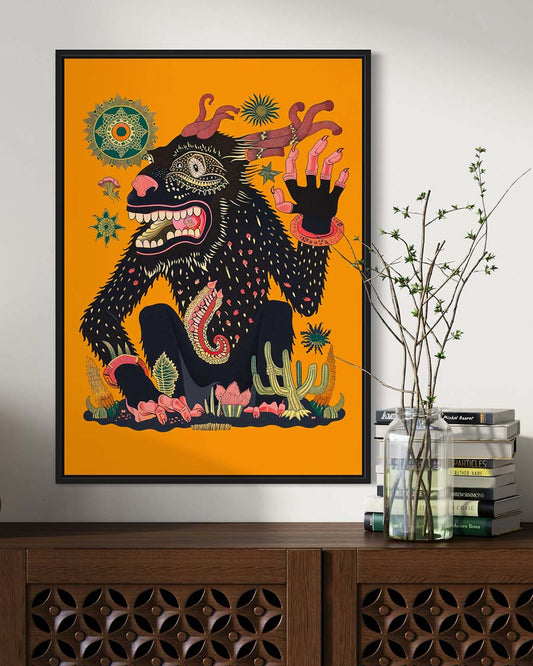 Framed art poster on the wall. The poster features an illustration of a strange creature waving its hand.