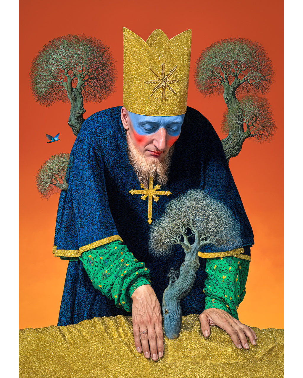 Surreal portrait of a crowned figure with blue and red face paint, wearing a dark robe and gold cross, leaning over a small tree against an orange background.