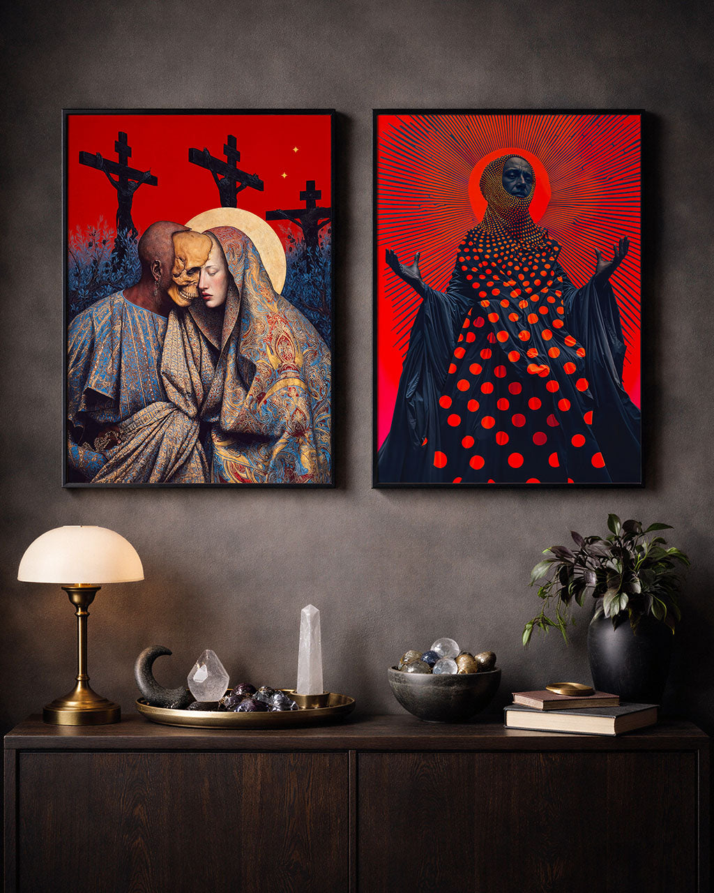 Two framed surreal art posters displayed side by side above a wooden cabinet in a moody interior setting.