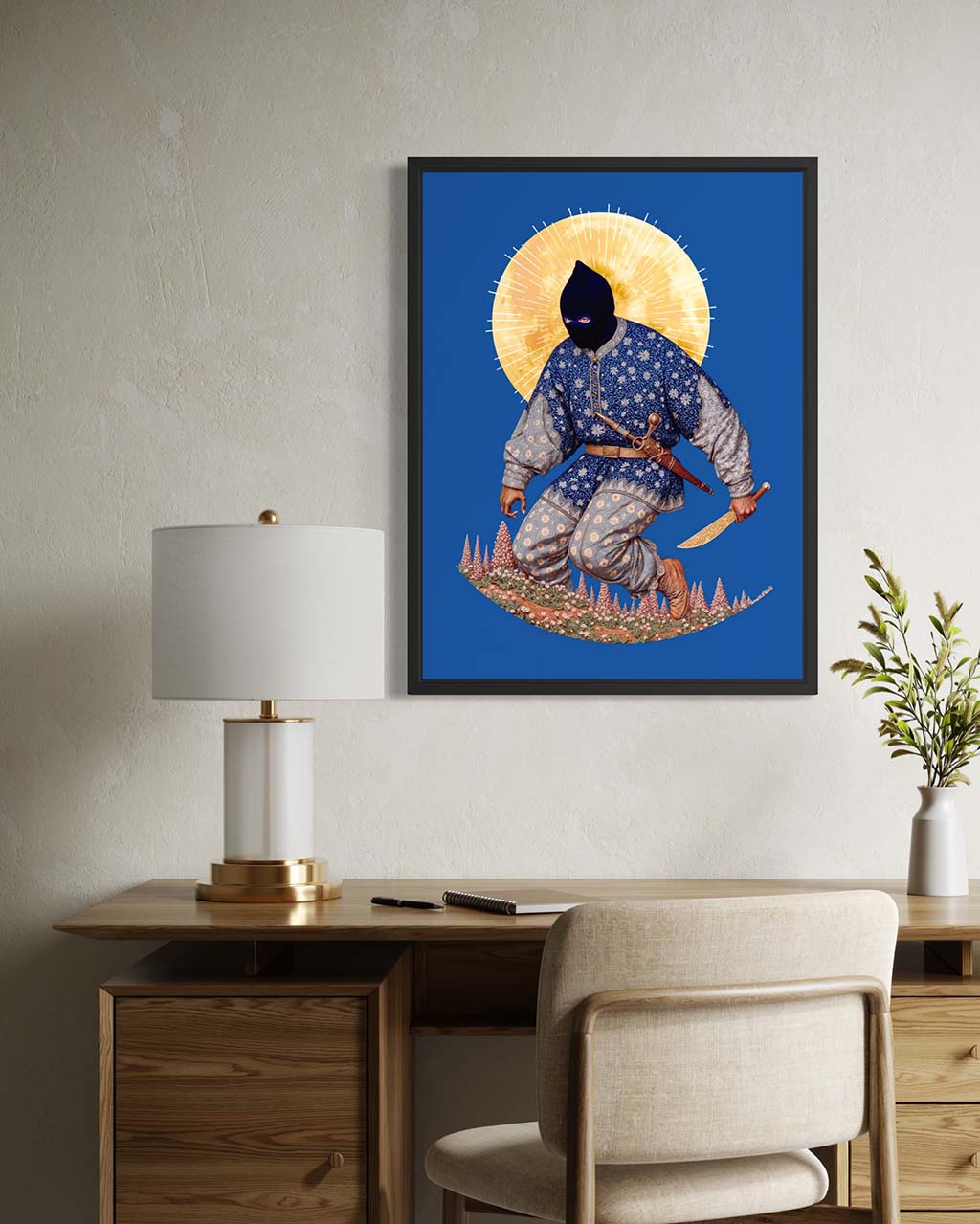 Framed artwork of a character in a blue outfit with a yellow circle on a wall above a desk.